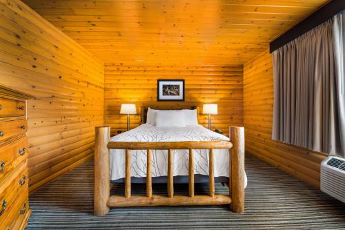 a bedroom with a bed in a log cabin at Best Western Park Oasis Inn in Mauston