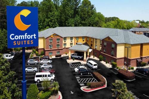 a sign in a parking lot in front of a hotel at Comfort Suites Morrow- Atlanta South in Morrow