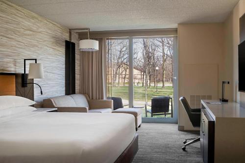 a hotel room with a bed and a large window at Lincolnshire Marriott Resort in Lincolnshire