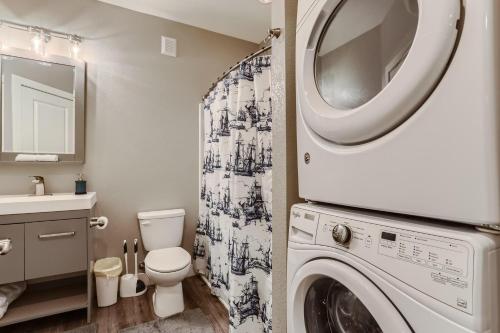 a bathroom with a washer and dryer at Central Park - 28th Place Apt in Aurora