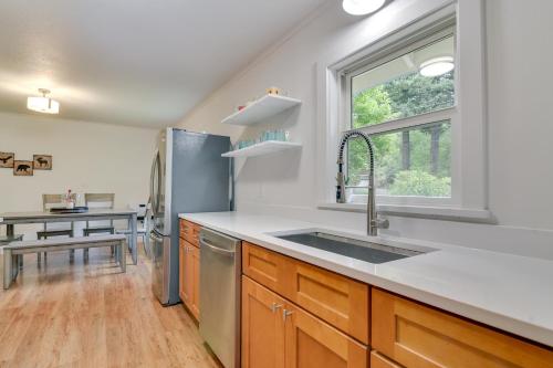 a kitchen with a stainless steel refrigerator and a sink at Downtown Home with Patio - Walk to Shops and Dining! in Stevenson