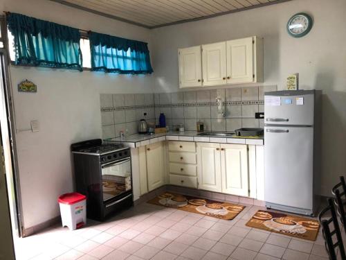a kitchen with white cabinets and a white refrigerator at GaVal Apart A in Posadas