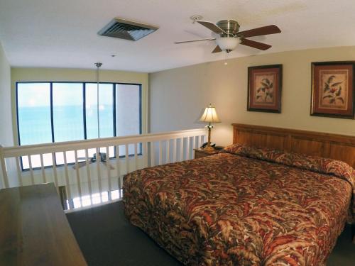 A bed or beds in a room at Island Gulf Resort, a VRI resort