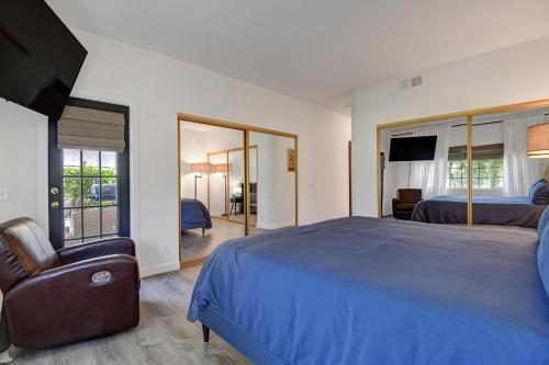 a bedroom with a large blue bed and a chair at DL882 - Desert Falls Poolside Escape in Palm Desert