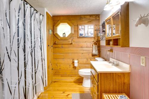 a bathroom with a toilet and a sink at Orleans Retreat with Private Hot Tub and Fireplace! 