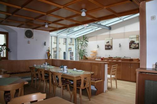 a dining room with wooden tables and chairs at Hotel Gasthof Hereth in Wirsberg