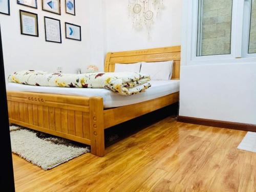 a bedroom with a wooden bed in a room at Primrose Homestay Cao Bang in Cao Bằng
