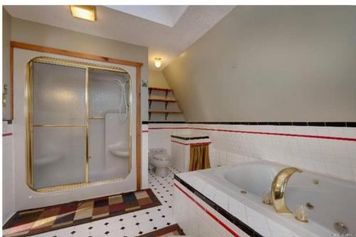 a bathroom with a tub and a toilet at 3 Bedroom 2 Bath Carriage House (Pet Friendly) in Bar Harbor