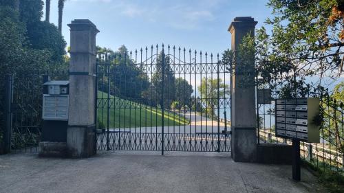 an iron gate with a large iron fence at La Suite dell'Artista SWIMMING POOL AND AIR CONDITIONING in Stresa