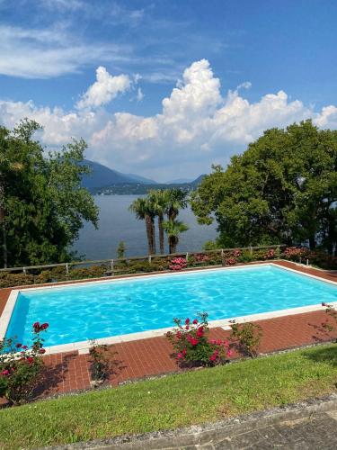 a large swimming pool with a view of the water at La Suite dell'Artista SWIMMING POOL AND AIR CONDITIONING in Stresa