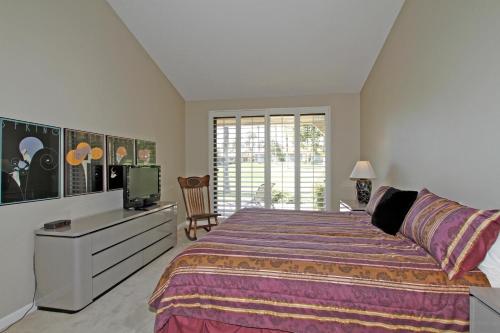 um quarto com uma cama grande e uma televisão em VY236 - Sunny Palm em Palm Desert