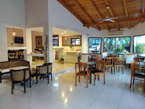 a dining room with tables and chairs and a kitchen at La Casona in Federación