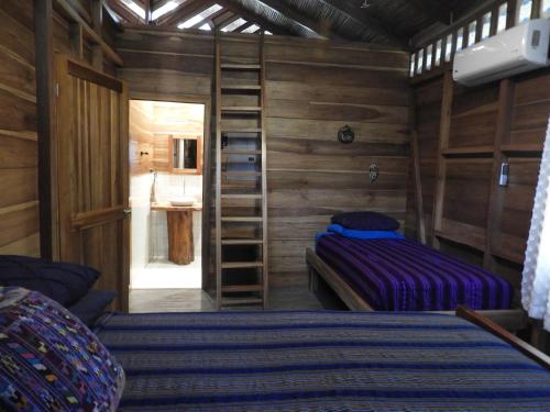 a bedroom with a bunk bed and a ladder at Casita Bribri at Margarita Hills in Cocles