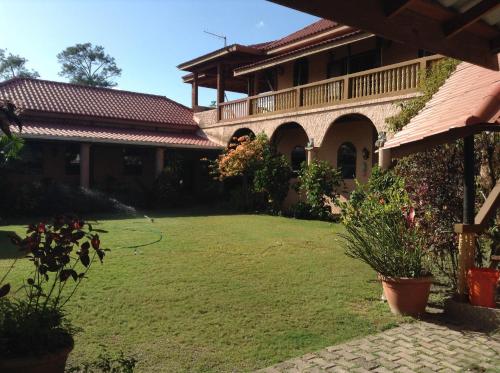 a yard in front of a large building at Becks Bed & Breakfast in Crooked Tree