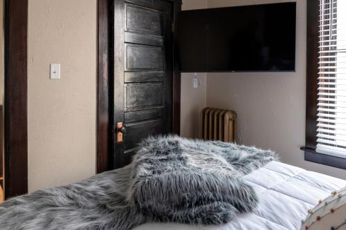 a bedroom with a bed with a fur blanket on it at Updated 3 bedroom unit with balcony! in Cape Girardeau