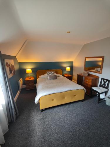 - une chambre avec un grand lit et deux lampes dans l'établissement Old Killarney, à Killarney