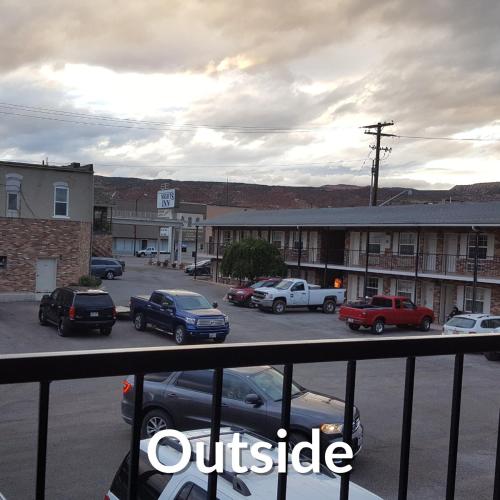 a view of a parking lot with cars parked at Nights Inn - Richfield in Richfield