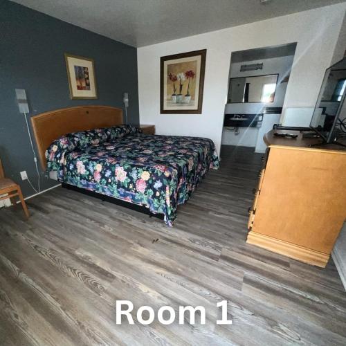 a bedroom with a bed and a wooden floor at Nights Inn - Richfield in Richfield