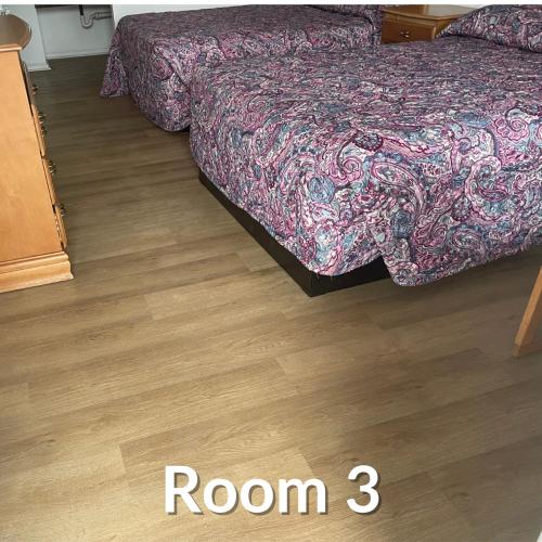a bedroom with two beds and a wooden floor at Nights Inn - Richfield in Richfield