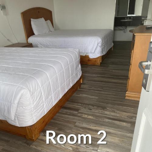 two beds in a hotel room with the words room at Nights Inn - Richfield in Richfield