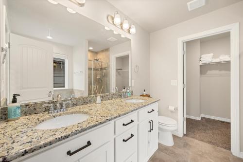 a white bathroom with a sink and a toilet at Mead Vacation Rental Fenced Backyard and Fire Pit! in Longmont