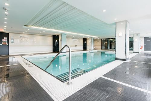 a large swimming pool in a building at Cozy & Contemporary Suite - Easy Access to Everything in Richmond Hill