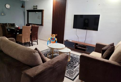 a living room with two couches and a tv at Homestay FourSeasons @ Bandar Baru Bangi in Bandar Baru Bangi
