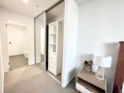 a bathroom with a mirror and a walk in shower at SkyPark Oasis Retreat 2Br@ close to Olympicpark in Sydney
