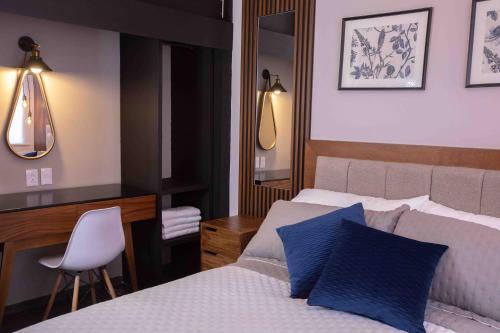 a bedroom with a bed and a desk and a chair at Morada Luna Polanco in Mexico City