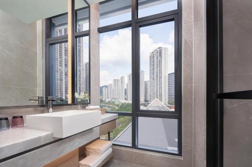 a bathroom with a sink and a large window at The Meixi Lake, Changsha Marriott Executive Apartments in Changsha