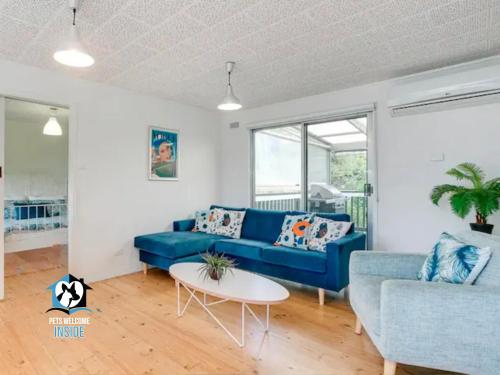 a living room with a blue couch and a table at Retro Groovy Pad Pt Elliot in Port Elliot