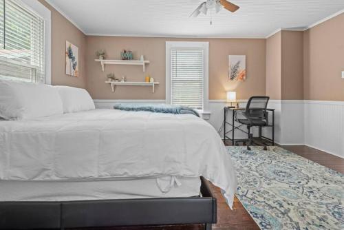 a bedroom with a large bed and a desk at 4 Bedroom House, sleeps 12, short walk to Main St! in St. Charles
