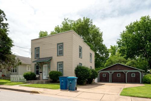 a house with two blue trash cans in front of it at 4 Bedroom House, sleeps 12, short walk to Main St! in St. Charles