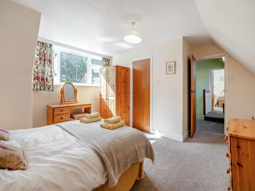 a bedroom with a large bed with towels on it at The Old School House in Inverey