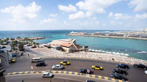 a parking lot with cars parked next to the ocean at Gorgeous Seaview Condo in Gleem in Alexandria