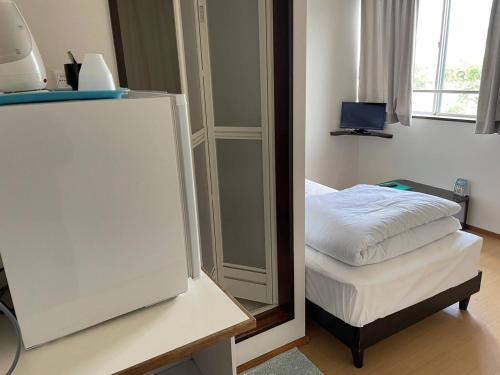 a bedroom with a mirror and a bed in it at Southern Village Okinawa - Vacation STAY 09953v in Kishaba