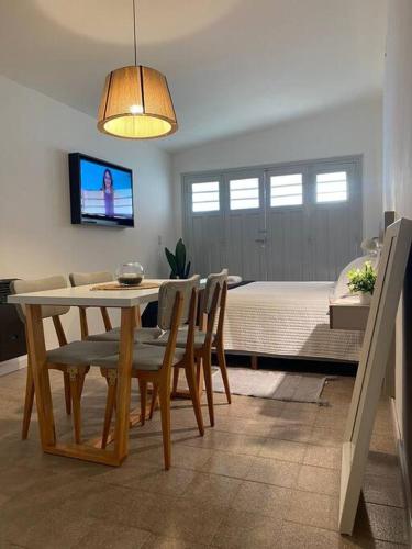 a dining room and living room with a table and chairs at Refugio Madryn relax in Puerto Madryn