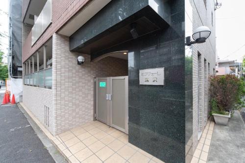 a building with a door on the side of it at Ihatov Komazawa in Tokyo