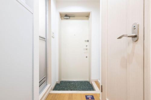 a bathroom with a walk in shower next to a door at Ihatov Komazawa in Tokyo