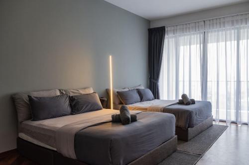 a bedroom with two beds and a couch at Large Family Seaview Suite 3 Rooms by The Only Bnb in Tanjong Tokong
