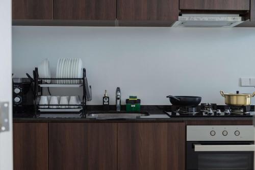 a kitchen with a stove and a counter top at Large Family Seaview Suite 3 Rooms by The Only Bnb in Tanjong Tokong