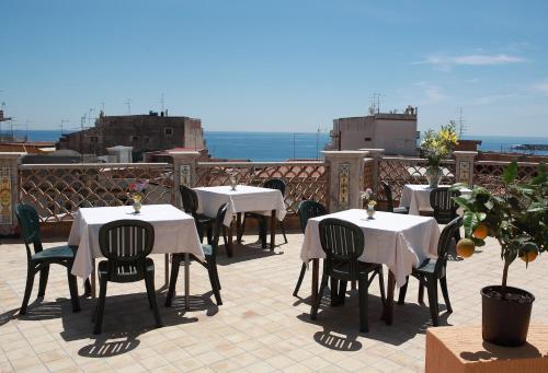a group of tables and chairs on a patio at Villa Cristina in Giardini Naxos