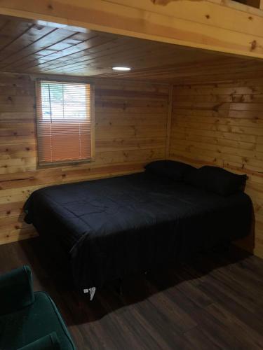 - une chambre avec un lit dans une cabane en rondins dans l'établissement Nana's, 