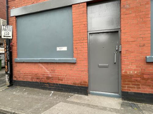 a brick building with two garage doors on it at Bethel Apartments in Leeds