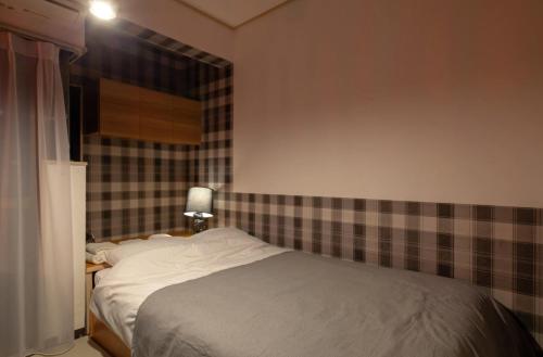 Кровать или кровати в номере SunPalace Nishi-Shinjuku