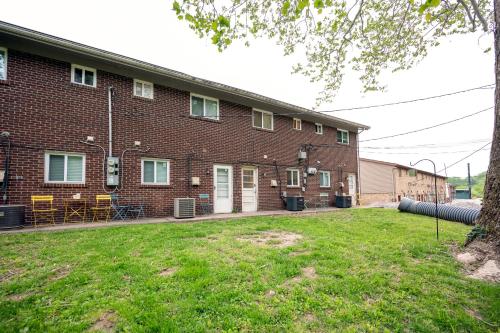 a large brick building with a lawn in front of it at Saint Charles 2 Bedroom Townhome Retreat in Earth City