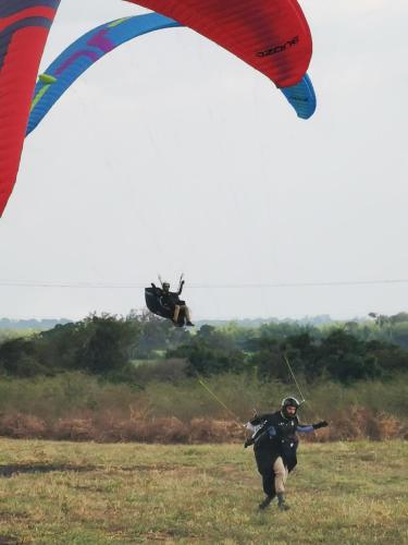 a man flying a kite in a field with a helicopter at VILLA CRISTAL in Santa Helena