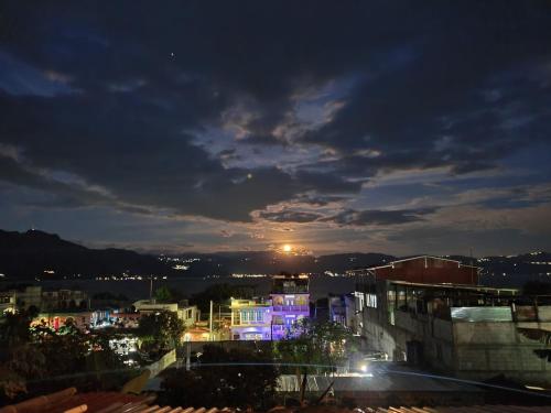 a view of a city at night at Casa Guillermo Batz in San Pedro La Laguna