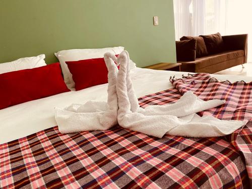 a pair of towel animals laying on a bed at VILLA CRISTAL in Santa Helena