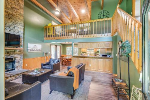 ein Wohnzimmer mit grünen Wänden und einer Treppe in der Unterkunft Hidden Hollow Lodge - Secluded Theater Room Game Room Pool Table Hot Tub Fire Pit More in Sevierville